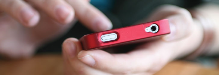 Close up view of someone dialing a cell phone