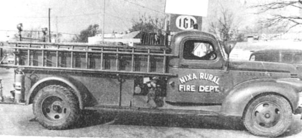 A historical photo of an old fire engine with the words "Nixa Rural Fire Dept." painted on the side